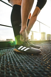 pair of black-and-white adidas cleats thumbnail