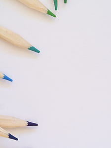 assorted-color pencils on white surface thumbnail