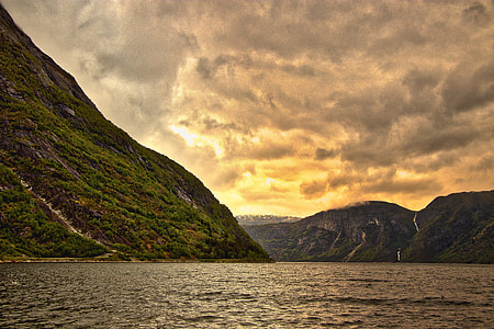 mountain near body of water during daytime thumbnail