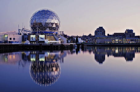 Grey Dome Building Beside Body of Water during Sunset thumbnail
