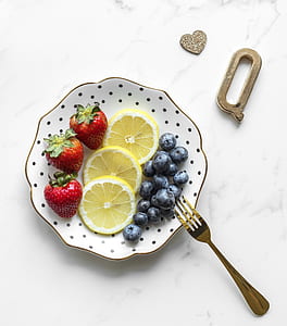 blueberries, strawberries, and lime slices on plate thumbnail