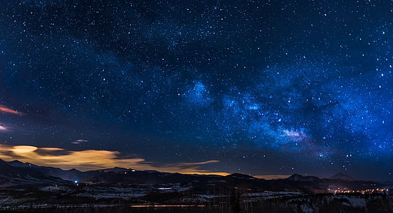 silhouette of mountains under blue sky during night time thumbnail