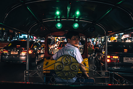 man in white polo shirt driving black and yellow auto rickshaw thumbnail