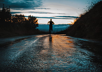 silhouette on person running on road thumbnail