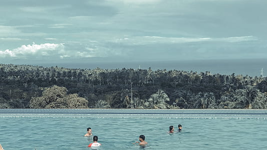 Group of People Swimming in Pool thumbnail
