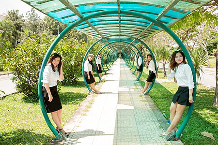 six women leaning on blue posts thumbnail