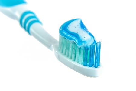 white and blue toothbrush with white and blue toothpaste thumbnail