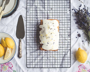flat-lay photography of sweet pastry beside cake knife and lemon thumbnail