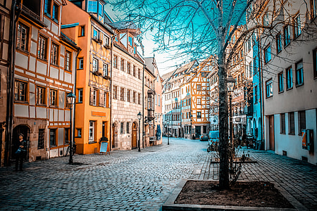 pathway between buildings during daytime thumbnail