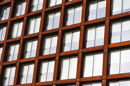 brown concrete building with glass window thumbnail