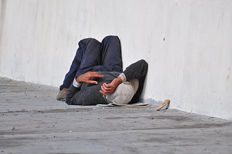 person sleeping on gray concrete floor thumbnail