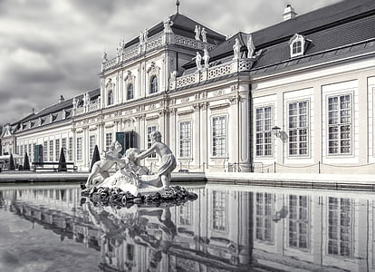two toddlers concrete statue on water fountain near building grayscale photography thumbnail