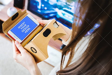 PSD Mockup. Girl uses her smartphone for Virtual Reality (VR). Cardboard. thumbnail