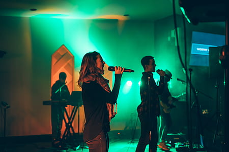 man and woman sitting in stage with green lights thumbnail