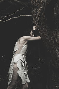 woman leaning on tree thumbnail