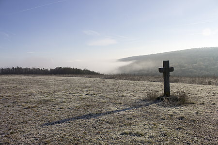 landscape photography of open field with brown cross thumbnail