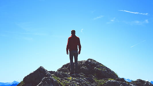 man standing on rock formation thumbnail