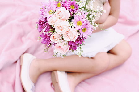 person sitting while holding bouquet of flowers thumbnail