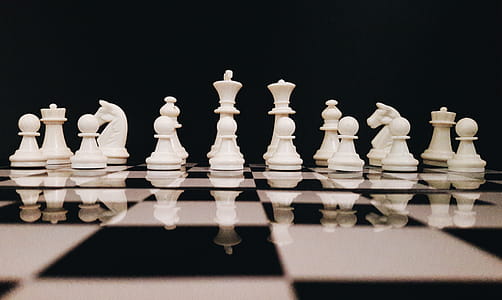 White Chess Piece on Top of Chess Board thumbnail