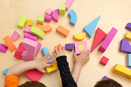 Children Sharing And Playing With Toys Photo thumbnail