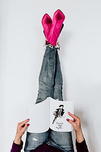 A woman in pink boots and blue jeans thumbnail