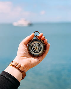 person holding compass thumbnail