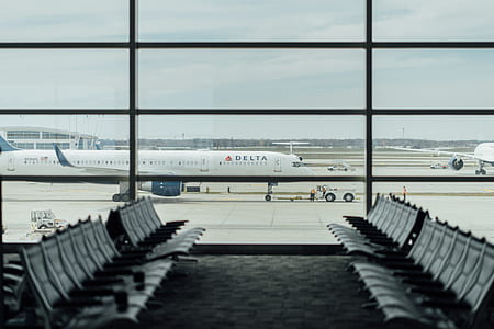white Delta airplane on airport thumbnail