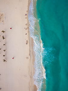 blue body of water beside of sandbank thumbnail