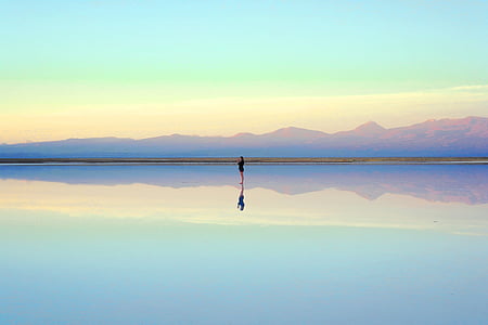 woman standing on body of water at daytime thumbnail