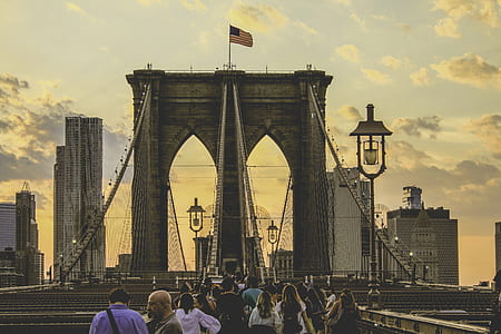 people walking towards brown concrete bridge thumbnail