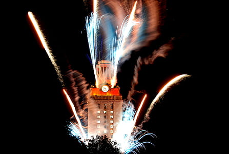 timelapse photography of fireworks near brown tower at nighttime thumbnail