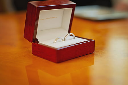 silver-colored wedding rings in red box thumbnail
