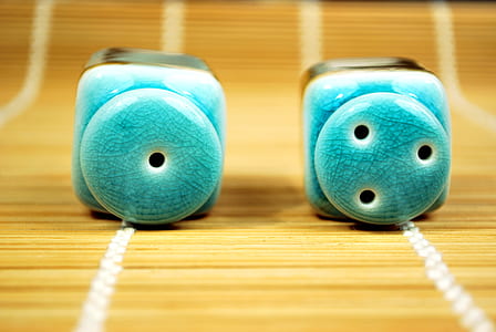 two blue ceramic condiment shakers on brown surface thumbnail