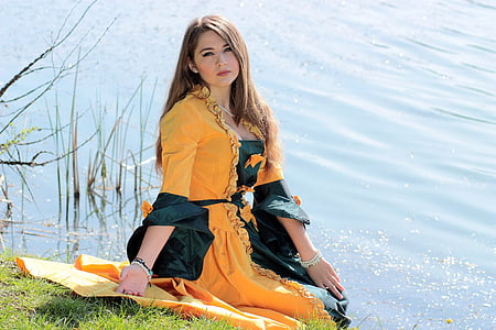 woman in yellow dress sitting on green grass thumbnail