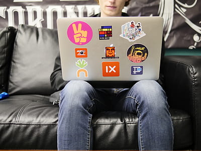 person wearing blue denim jeans sitting using gray laptop thumbnail