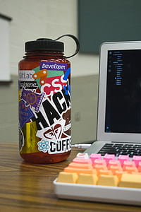 white laptop computer beside multicolored keyboard, and Developer bottle thumbnail
