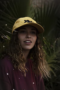 woman wearing yellow cap and red top thumbnail