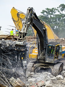 yellow and black heavy equipment drilling concrete pavements during daytime thumbnail