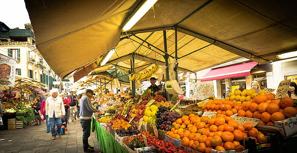 man wearing gray jacket and pants buying on fruit market thumbnail