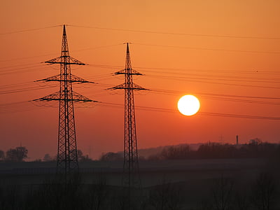transmission towers against sunset thumbnail