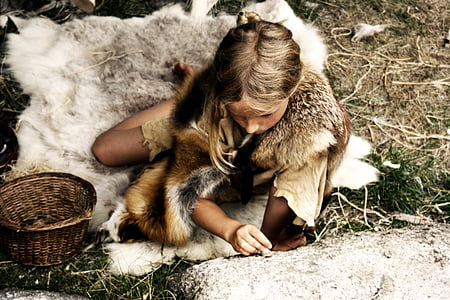 woman wearing animal hide sitting on grass thumbnail