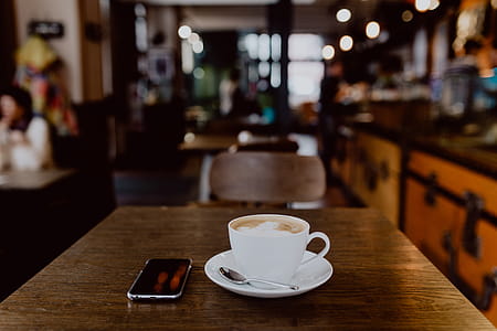 Cup of coffee on table in cafe thumbnail