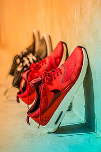 Focus Photography of Pair of Red Nike Running Shoes thumbnail