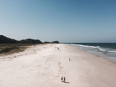 person walking on seashore thumbnail