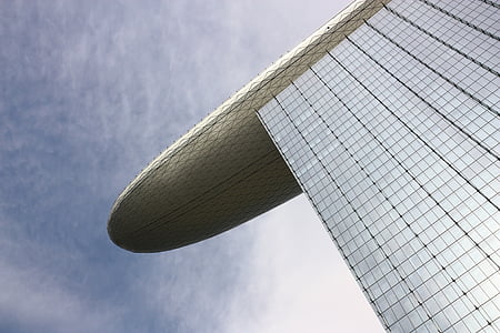 shallow focus photography of white curtain wall building under white cloudy skies at daytime thumbnail