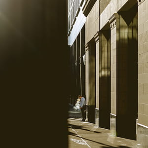 Man standing next to a building thumbnail