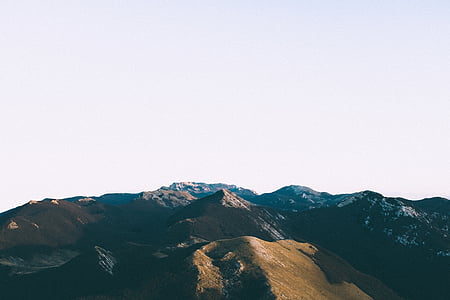 aerial photo of green mountains under white sky during daytime thumbnail