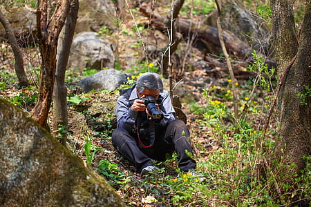 man taking photo on plant thumbnail