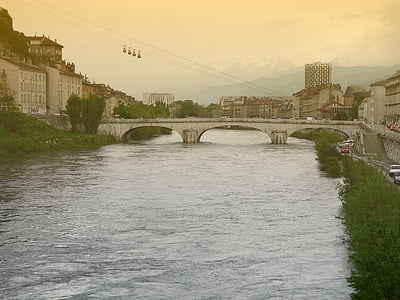 white concrete bridge on river near cityscape during golden hourse thumbnail