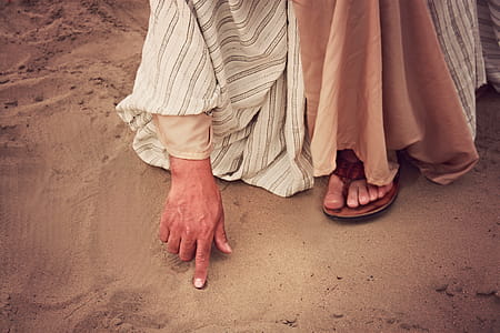 Person Touching Sand With Right Index Finger thumbnail